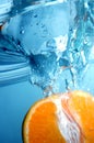 Fresh orange into blue, clear water Royalty Free Stock Photo