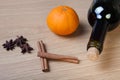 Fresh orange, bottle of vine and spices on a light wooden table Royalty Free Stock Photo