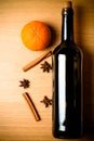 Fresh orange, bottle of vine and spices on a light wooden table. Royalty Free Stock Photo