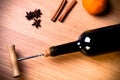 Fresh orange, bottle of vine and spices on a light wooden table. Royalty Free Stock Photo