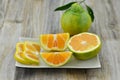 Fresh orange cut half in plate on wooden background Royalty Free Stock Photo