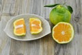 Fresh orange cut half in plate on wooden background Royalty Free Stock Photo