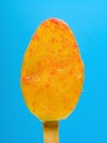 fresh orange flavor popsicle on blue background Royalty Free Stock Photo