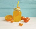 Fresh orange fresh clear glass with straw morning white and blue wooden, mandarins