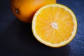 Fresh orange fruit slice half dark background Royalty Free Stock Photo