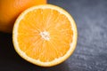 Fresh orange fruit slice half dark background Royalty Free Stock Photo