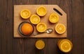 Fresh orange fruits whole and squeezed on a wooden table, cutting board - natural and healthy food. Glass of fruit cocktail Royalty Free Stock Photo