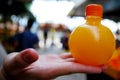 Fresh Orange juice bottle on the hand - beverage drink scene for take a way