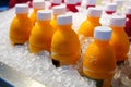 Fresh Orange juice bottles on the ice box in market Royalty Free Stock Photo
