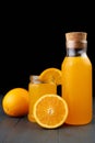 fresh orange juice in a glass jar and bottle with fresh fruits on wooden table Royalty Free Stock Photo