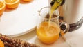 Fresh orange juice in a glass jug close up on white background. Royalty Free Stock Photo
