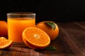 Fresh orange juice in glass and oranges fruit on wooden table background Royalty Free Stock Photo