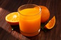 Fresh orange juice in glass and oranges fruit on wooden table background Royalty Free Stock Photo