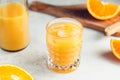 Fresh orange juice with ice cubes in a glass on a table. Royalty Free Stock Photo