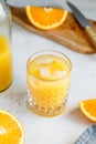 Fresh orange juice with ice cubes in a glass on a table Royalty Free Stock Photo