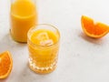 Fresh orange juice with ice cubes in a glass on a table Royalty Free Stock Photo