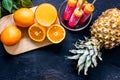 Fresh orange juice, oranges, pineapple and citrus ice cream on black table background top view copyspace Royalty Free Stock Photo