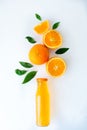 Fresh orange juice with oranges and orange slices on white table