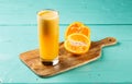Fresh Orange Juice with raw oranges served in a glass isolated on cutting board side view healthy fruit juice Royalty Free Stock Photo