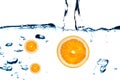 Fresh orange jumping into water Royalty Free Stock Photo