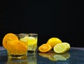 fresh orange and lemon in juice glass, near slice orange and lemon Royalty Free Stock Photo