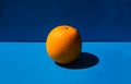 Fresh orange lying on a blue background