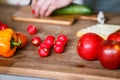 Fresh orange pepper, radish and red apples on the wooden board