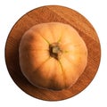 Fresh orange pumpkin with green veins on wooden board top view. Halloween preparation