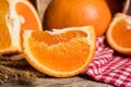 Fresh orange slice and whole orange on a wooden table