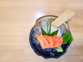 Fresh orange sliced salmon or Salmon Sashimi in the bowl on the wooden table Royalty Free Stock Photo