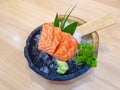 Fresh orange sliced salmon or Salmon Sashimi in the bowl on the wooden table