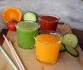 Fresh orange,tomato and cucumber smoothie on a glass.