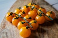 Fresh orange yellow tomatos cherry on wood table