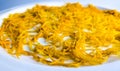 Fresh orange zest on a white plate. Raw citrus zest, grated orange peel, fresh zest on a white background Royalty Free Stock Photo