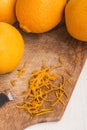 fresh orange and zester to obtaining orange zest on an old wooden board