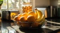 Fresh oranges and bananas in wire fruit basket on kitchen countertop in sunlight Royalty Free Stock Photo