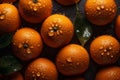 Fresh oranges on a dark background, some whole and some cut in half, covered in water droplets. Royalty Free Stock Photo