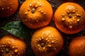 Fresh oranges on a dark background, some whole and some cut in half, covered in water droplets.