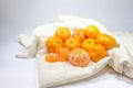 The fresh oranges fruit are arranged on a white cloth background. Royalty Free Stock Photo