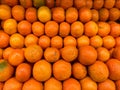 Fresh oranges on fruit market, close up. Organic fruit display in shop. Juicy oranges. Royalty Free Stock Photo