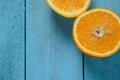 Fresh oranges halves fruits on blue wooden background with copy space Royalty Free Stock Photo