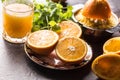 Fresh oranges juicer juice tropical fruits and herbs on concrete board Royalty Free Stock Photo