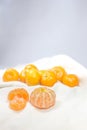 The fresh oranges lay on a white cloth as a background.