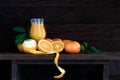 fresh oranges with leaf and orange juice in glass on wooden table with plank wood background,still light style image with Royalty Free Stock Photo