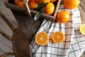 Fresh oranges with leaves and rustic box on wooden table Royalty Free Stock Photo