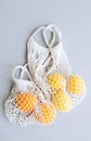 Fresh oranges and lemons in eco net shopping bag on gray background Royalty Free Stock Photo