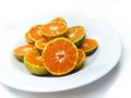 Fresh oranges on the plate isolated on white background Royalty Free Stock Photo