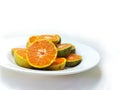 Fresh oranges on the plate isolated on white background Royalty Free Stock Photo