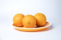 Fresh oranges on a plate isolated on a white background Royalty Free Stock Photo
