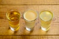 Fresh organic apple cider with apples and cinnamon over rustic wooden background. Close up three glasses Royalty Free Stock Photo